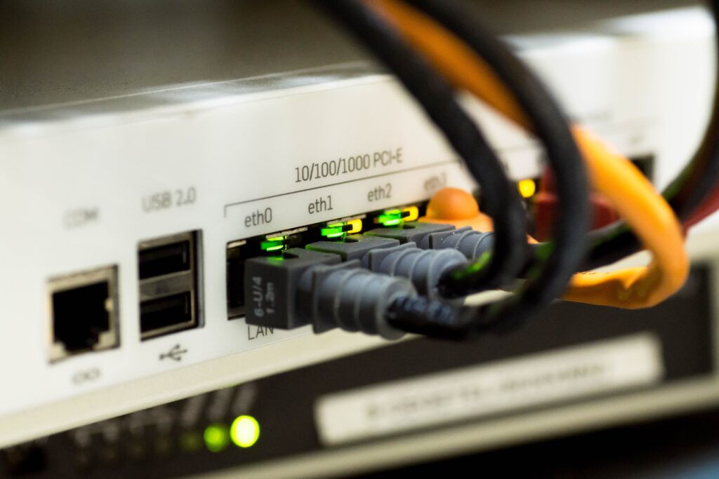close up of the back of a router with different cables going into it