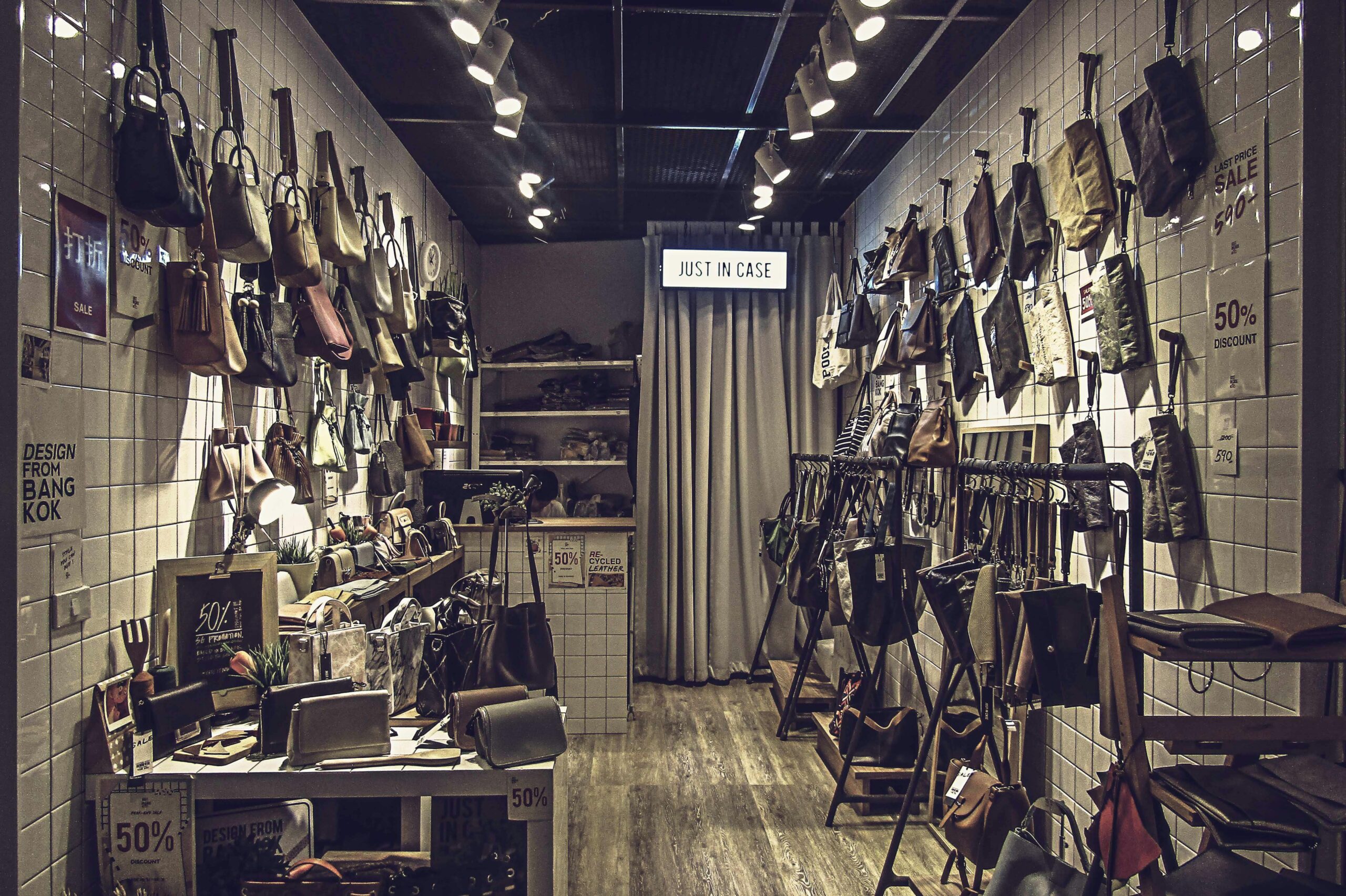 a retail outlet with displays of bags and clothing.