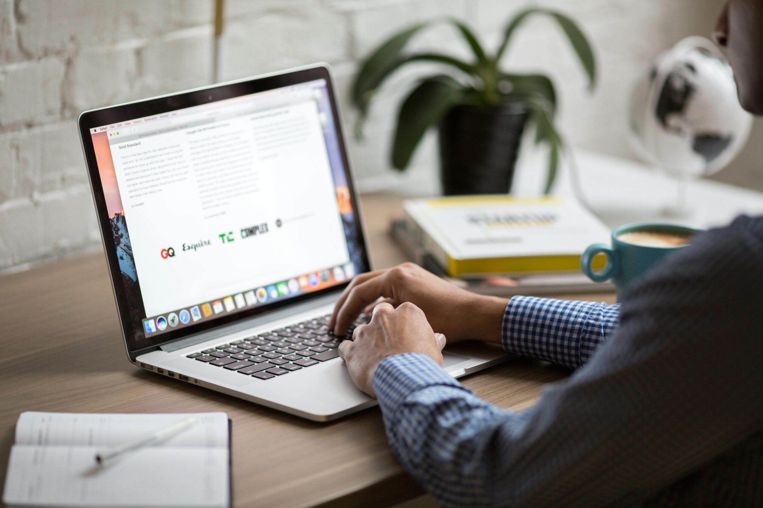 a person sat at a desk only hands in shot in front of a laptop